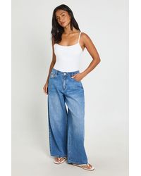 Boohoo - Petite Mid Waist Loose Fit Wide Leg Jean - Lyst