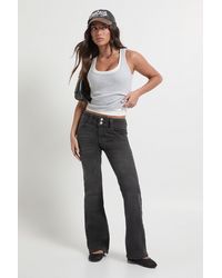 Boohoo - Petite Low Waist Double Button Flared Jean - Lyst