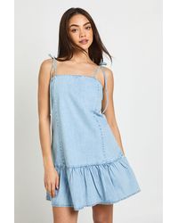 Boohoo - Strappy Dropped Hem Denim Mini Dress - Lyst