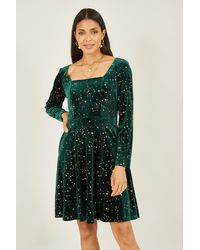 Mela London - Star Foil Print Long Sleeve Skater Dress - Lyst