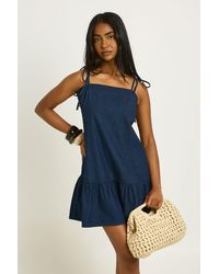 Boohoo - Strappy Dropped Hem Denim Mini Dress - Lyst
