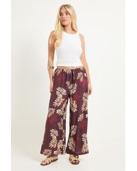 Wallis - Petite Palm Print Drawstring Trousers - Lyst