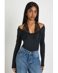 Boohoo - Matte Slinky Long Sleeve Lace Trim Halter Neck Bodysuit - Lyst