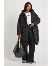 Boohoo - Plus Belted Longline Puffer Jacket - Lyst
