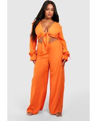 Boohoo - Plus Woven Knot Front Long Sleeve Jumpsuit - Lyst