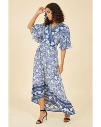 Yumi' - Border Floral Print Wrap High Low Maxi Dress - Lyst