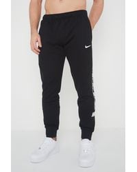 Nike - Repeat Taping Logo Fleece Cuffed Joggers - Lyst