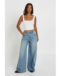 Boohoo - The Petite Mid Waist Wide Leg Jean - Lyst