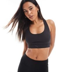 PUMA - Evolve Training Mid Impact Support Sports Bra - Lyst
