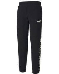 PUMA - Amplified Track Pants Taped Logo Joggers - Lyst