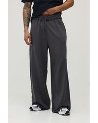 BoohooMAN - Extreme Wide Leg Loopback Script Embroidered Raw Hem Joggers - Lyst