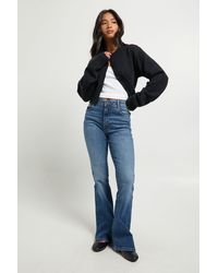 Boohoo - Petite High Waist Booty Lifting Flared Jean - Lyst
