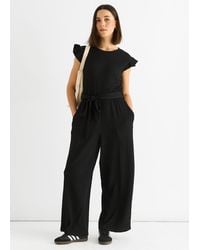 Gini London - Schwarzer Jumpsuit Mit Elastischer Taille Und Rüschen Aus Stretch-Material - Lyst