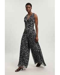 Karen Millen - Petite Polka Dot Crinkle Cross Back Georgette Woven Jumpsuit - Lyst