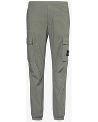 Stone Island - Logo-badge Tapered-leg Stretch-cotton Cargo Trousers - Lyst