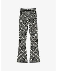 Sandro - Floral-print Flared-leg Stretch-knit Trousers - Lyst