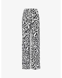 Stine Goya - Brand-print Wide-leg High-rise Woven Trousers - Lyst
