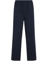 Prada - Triangle-Logo Patch Elasticated Waistband Trousers - Lyst