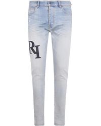 Amiri - Staggered Logo Skinny Jeans - Lyst