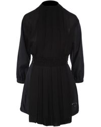 Prada - Logo Plaque Long Sleeved Pleated Playsuit - Lyst