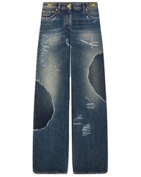 Versace - Logo-Patch Distressed Jeans - Lyst