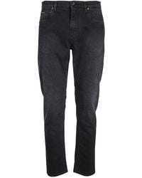 Dolce & Gabbana - Logo Plaque Tapered Leg Jeans - Lyst