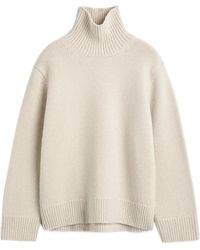 TOTEME - Oversized Lambswool Turtleneck Sweater Almond - Lyst