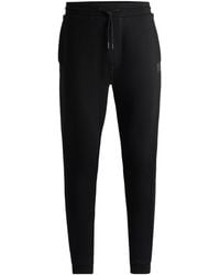 BOSS - Solid Color Cuffed Casual Pants - Lyst