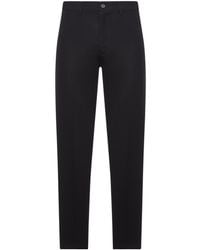Prada - Logo Plaque Pleated Trousers - Lyst