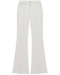 McQueen - Raw Finish Flared Jeans - Lyst