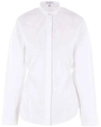 Alaïa - Alaïa Long-Sleeved Curved Hem Shirt - Lyst