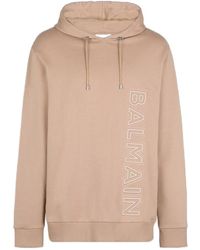 Balmain - Logo Embossed Drawstring Hoodie - Lyst