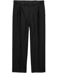 Prada - Triangle-Patch Pleated Trousers - Lyst