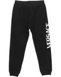 Versace - Logo Printed Tapered Track Trousers - Lyst