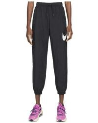 Nike - Swoosh-Print Tapered Track Pants - Lyst