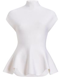 KHAITE - Andra Peplum Knit Top - Lyst