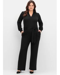 Sheego - Jumpsuit mit Bindegürtel und Reißverschluss vorn - Lyst