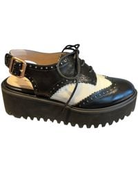 All Black - Spectator 23 Mules - Lyst