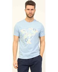 Guess - T-shirt T-shirt à col rond en coton avec logo imprimé - Lyst