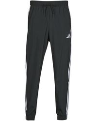 adidas - Trainingsbroek Essentials 3-Stripes Woven Joggers - Lyst