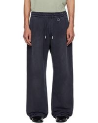 WOOYOUNGMI - One-Tuck Dyed Cotton Sweatpants - Lyst
