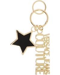 Versace - Porte-clés noir et doré à breloque d'étoile - Lyst