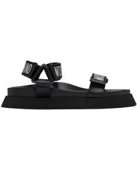 Moschino - Sandales noires à logos - Lyst