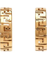 Versace Boucles d'oreilles à anneau dorées à méduseà motif à clé grecque - Métallisé