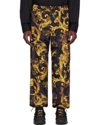 Versace - Pantalon noir et doré à motif watercolor couture - Lyst