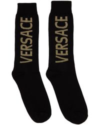 Femme Vêtements Chaussettes & Bas Chaussettes Chaussettes à logo en intarsia Coton Versace en coloris Noir 