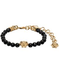 Versace - Bracelet noir et doré à méduses - Lyst