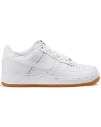 nike air force 1 sneakers with navy swoosh and gum sole