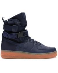 nike air force 1 trainers with navy swoosh and gum sole