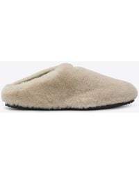Prada - Triangle Logo Shearling Flat Mules - Lyst